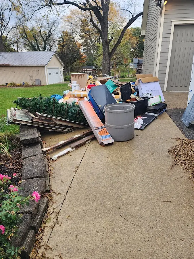 Dumpster being loaded with debris for Roofing Dumpster Rental in Double Oak